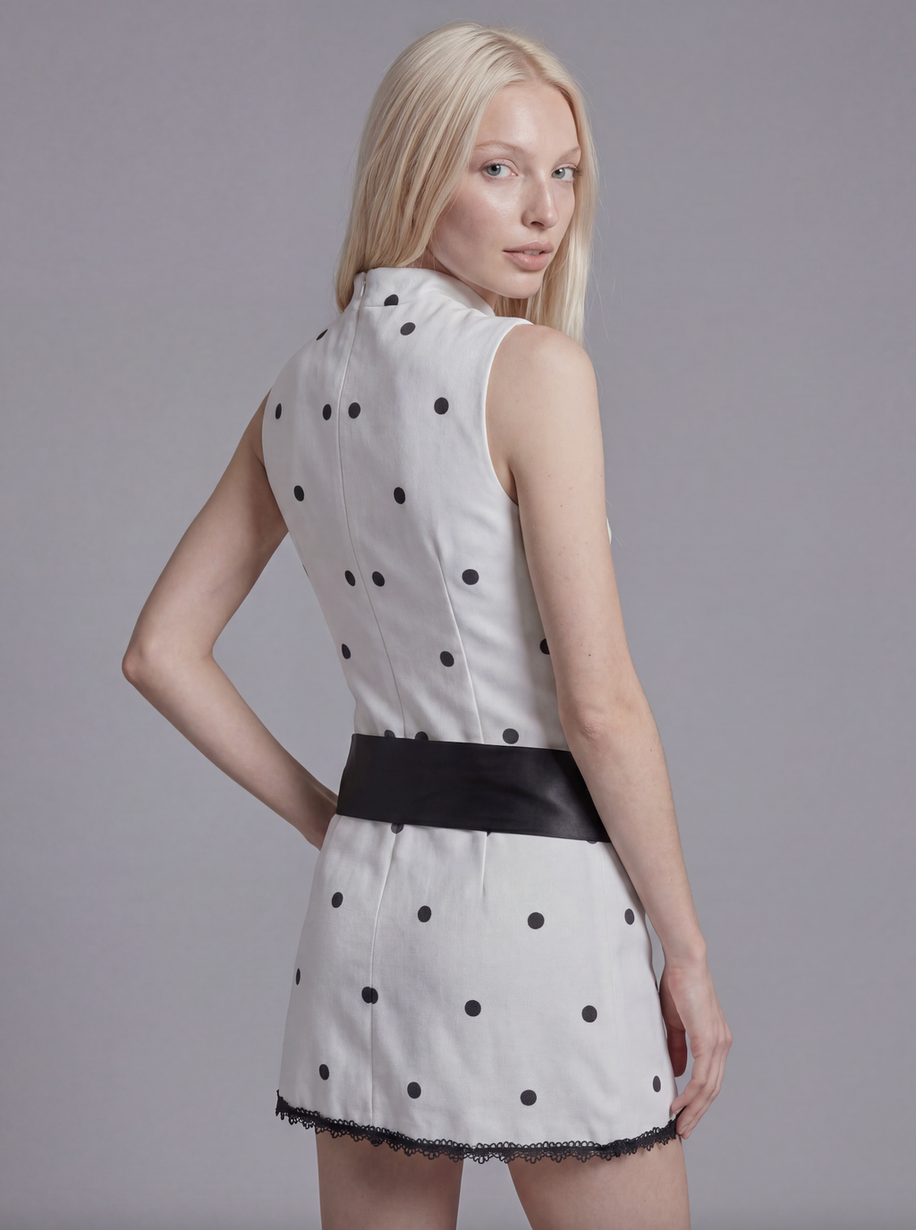 Sleeveless Polka Dot Mini Dress with Mock Neck and Satin Bow Waist Detail