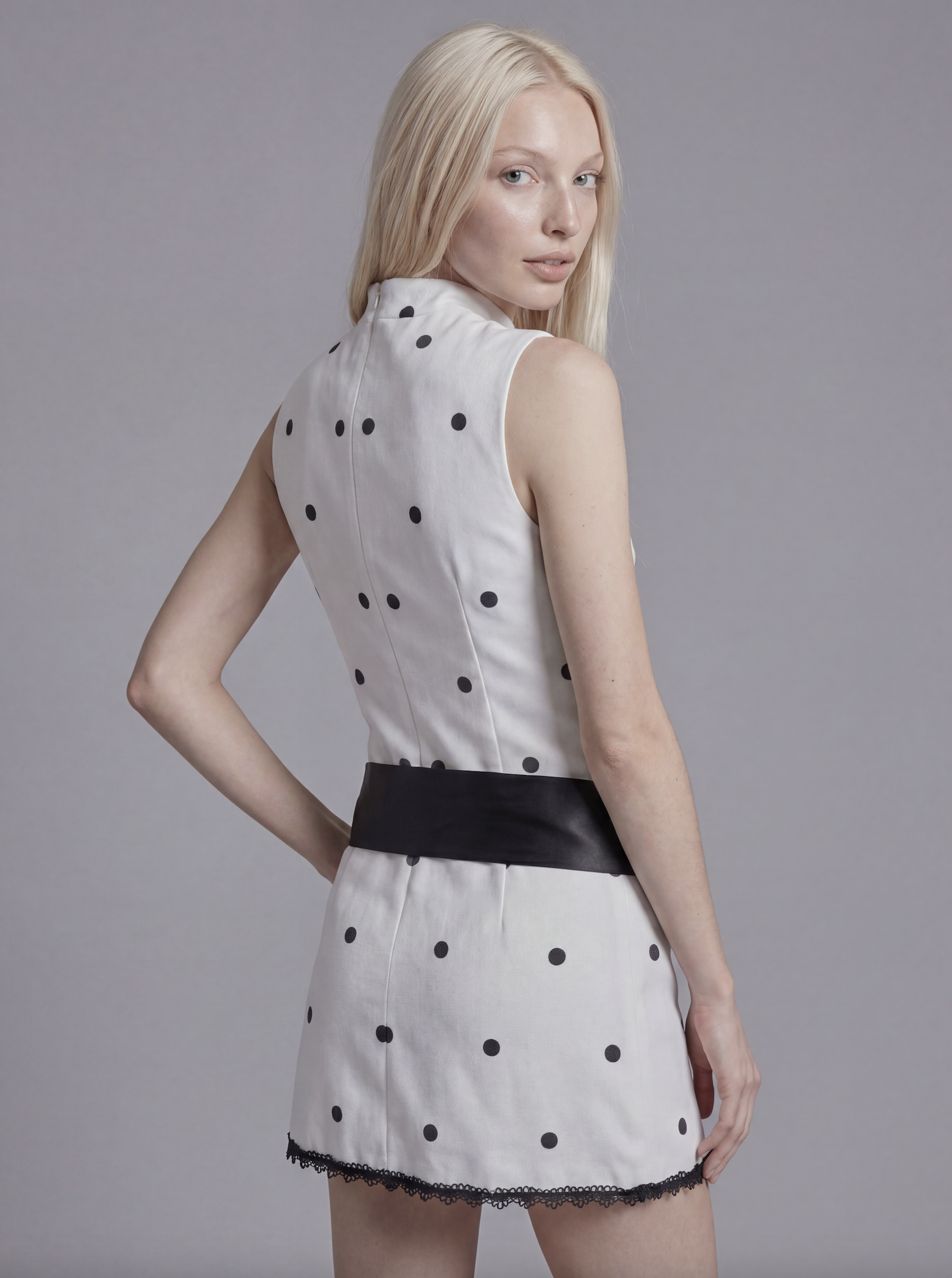 Sleeveless Polka Dot Mini Dress with Mock Neck and Satin Bow Waist Detail