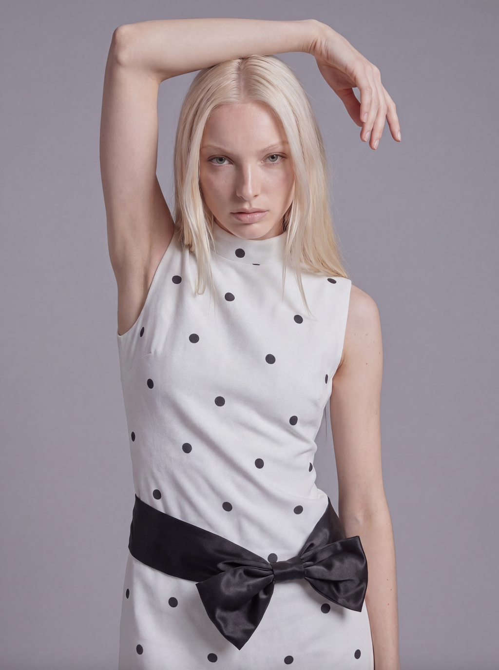 Sleeveless Polka Dot Mini Dress with Mock Neck and Satin Bow Waist Detail